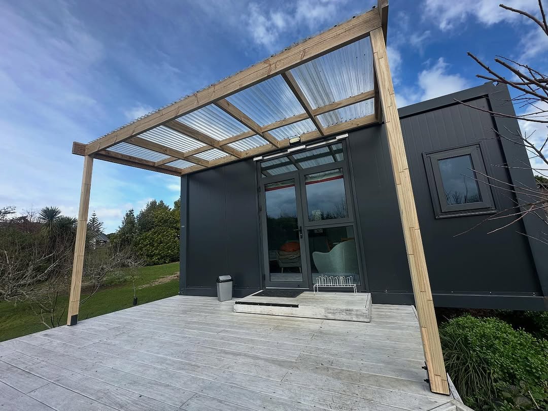 Timber pergola with clear roofing sheets fixed over the deck at a Pukekohe Airbnb
