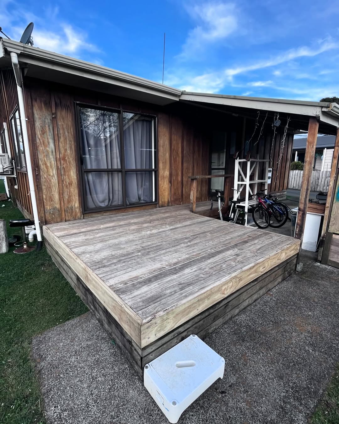 Weathered grey timber deck in Waihi NZ before its makeover — boards past their best