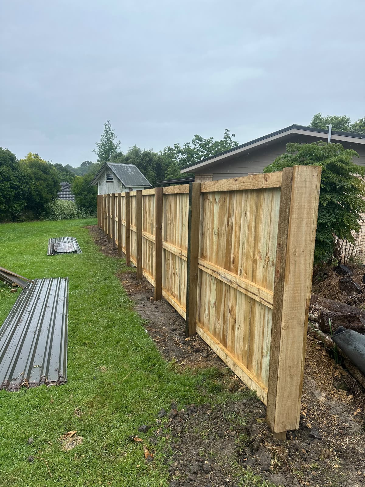 New timber paling fence in Waiuku with posts set plumb, rails hung and palings fixed