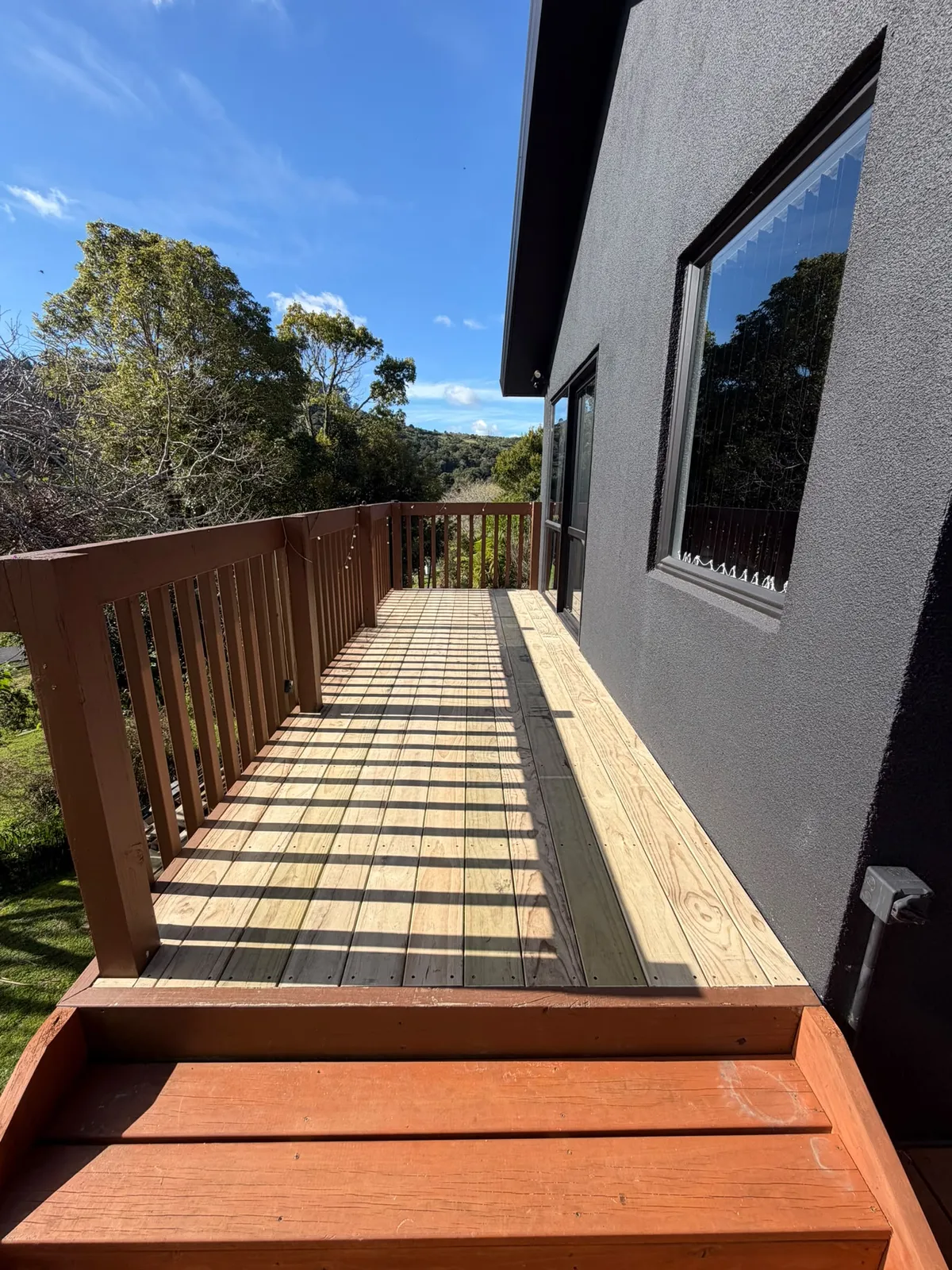 Balcony deck after the relay — new boards laid with wider drainage gaps
